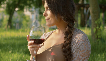 Woman drinking wine outdoors