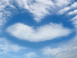 Naklejka na ściany i meble Heart-shaped clouds in the blue sky during the day