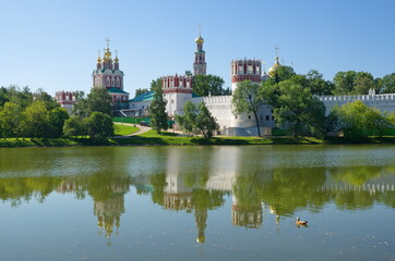 Fototapeta na wymiar View of the Novodevichy monastery and the Big Novodevichy pond on a Sunny summer day. Moscow, Russia