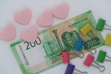 Two hundred rubles banknote, multi-colored paper clips, obligations
