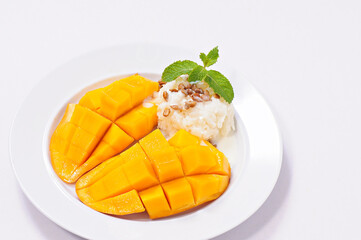 mango and sticky rice Pour the coconut milk, topping with sunflower seed on white background