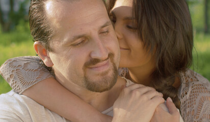 Fototapeta premium Portraits of kissing couple outdoors