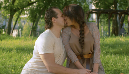Fototapeta premium Portraits of beautiful couple kissing in the park