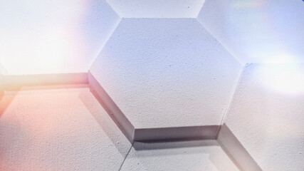 different level surface of the elements in the form of honeycombs, white with light glare, blurred background