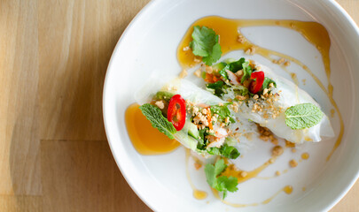 Spring rolls served with shrimp on a white plate. Cooking. National cuisine