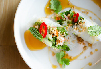 Spring rolls served with shrimp on a white plate. Cooking. National cuisine