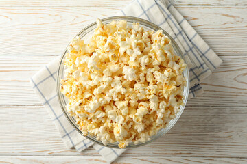 Bowl with popcorn on white wooden background. Food for watching cinema