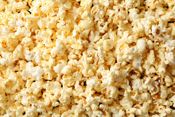 Tasty popcorn on whole background. Food for watching cinema