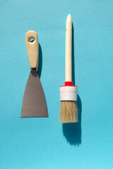 Spatula and brushes. Set of items for repair. Top view of a builder with a brush and spatula