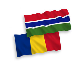 National vector fabric wave flags of Romania and Republic of Gambia isolated on white background. 1 to 2 proportion.