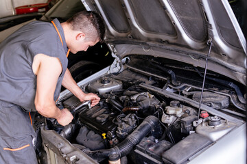 Fototapeta na wymiar Mechanic working with a wrench on the car engine.
