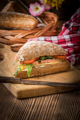 Triangular sandwich with cheese, ham and tomato.