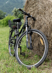 bicycle placed on a bale of hay