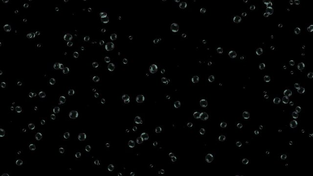 A large number of small soap bubbles evenly distributed across the black screen fly in a horizontal direction.