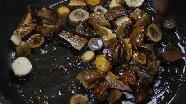 Mushrooms are cooked in a pan. Close-up