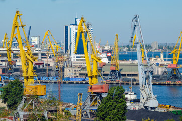 Port cargo crane loads a container onto a cargo ship