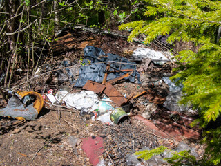 Pile of garage on green grass in the nature environment problems. Nature protection.