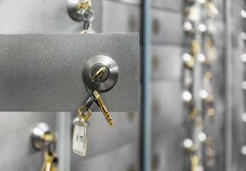 Open doors of deposit boxes with keys in the lock. Bank depository