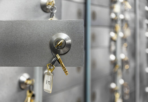 Open doors of deposit boxes with keys in the lock. Bank depository
