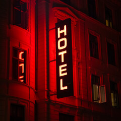 Hotel sign in red neon light at night