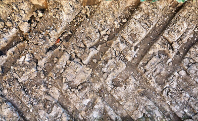 Close up of tractor tracks on a field as an agricultural background.