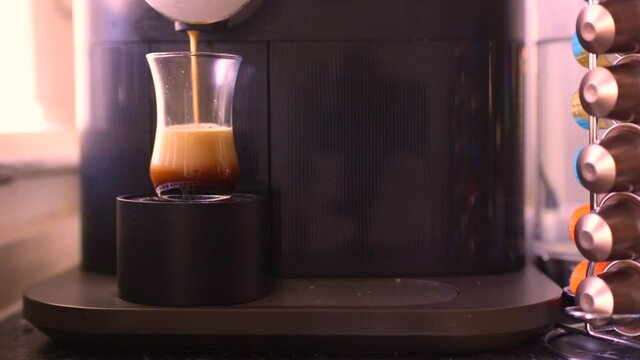 Espresso coffee being made with a nespresso machine