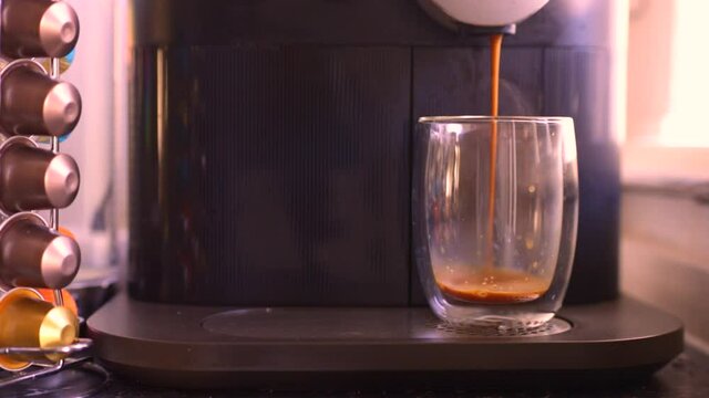 Espresso coffee being made with a nespresso machine