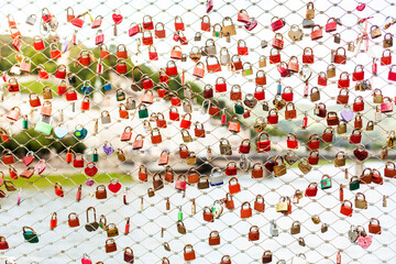 Padlocks for friendship and love locked on bridge. Vorhängeschlösser für Freundschaft und Liebe hängen an Brücke.