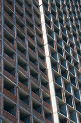 Abstract modern architecture fragment with concrete floors and walls with red bricks under construction