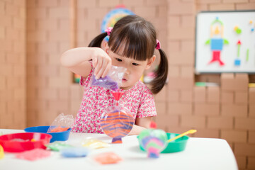 toddler girl making sand animal crafts for homeschooling