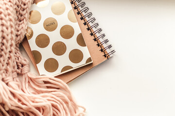Details of still life on window. Notebook with knitted scarf.