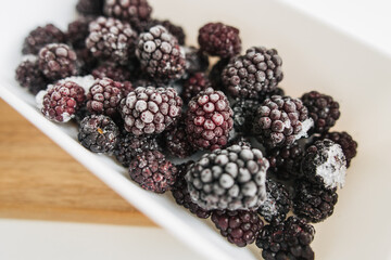 frozen blackberries in a lunch box on white background