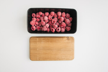 frozen raspberry in a lunch box on white background