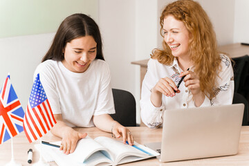 Teacher of english asks student in white class. 2 girls student answers to teacher. Working in...