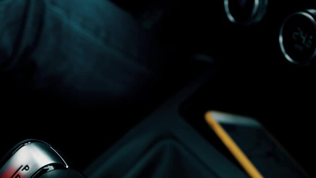 Man switches car automatic shift knob to drive. Starting a road trip