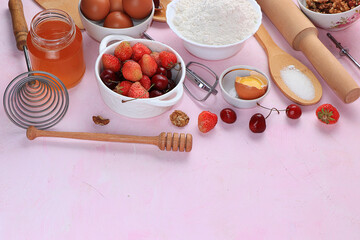 The recipe for making strawberry cherry pie. Eggs, flour, Sazar, strawberries and honey, top view, flat lay. Background of bakery products, the concept of a modern bakery