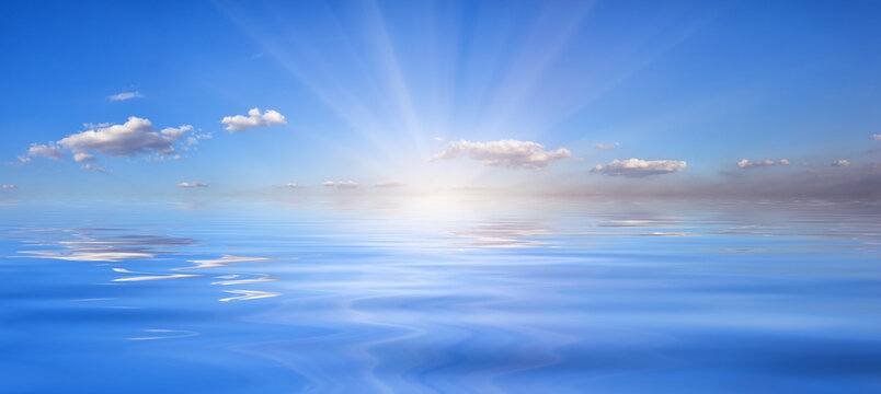 Blue sky with sun over the water © alexlukin