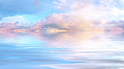 Tender pink dawn sky over water