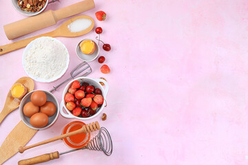 The recipe for making strawberry cherry pie, cooking. Eggs, flour, Sazar, strawberries and honey, top view, flat lay. Background of bakery products, the concept of a modern bakery