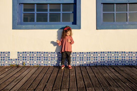 Girl standing on a wooden boardwalk, Armacao dos Buzios, Rio de Janeiro, Brazil