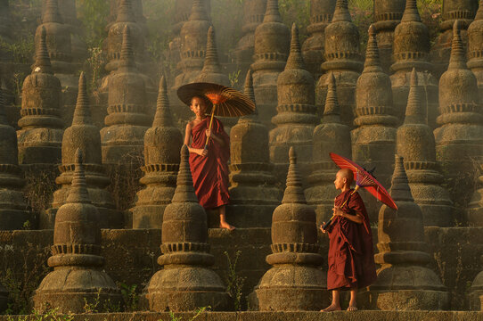Two novice monks walking amongst stupas, Bagan, Mandalay, Myanmar