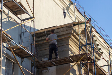 Worker on scaffolding at restoration work