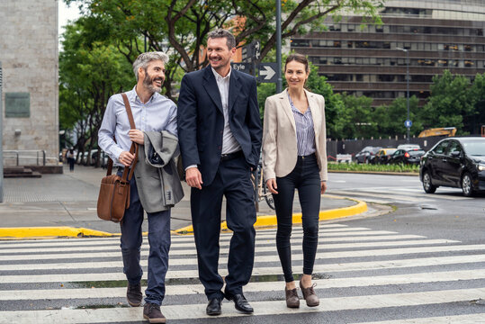 Businesspeople walking on pedestrian crossing