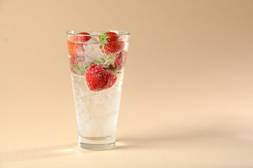  cocktail glass with red strawberries, sparkling water on bubbles on a beige background. High quality photo