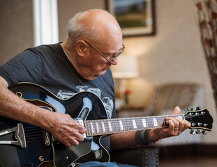 Senior man playing guitar