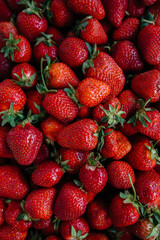 Ripe fresh strawberries close-up in a container for sale. Healthy diet