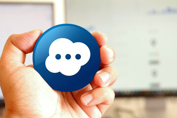 Brain icon blue round button holding by hand infront of workspace background