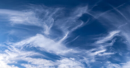 Stunning cirrus cloud formation panorama in a deep blue sky
