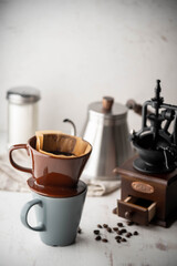 dripping coffee image with mug , paper filter and kettle
