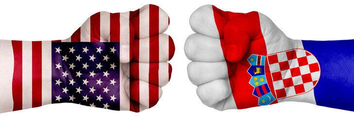 Fototapeta premium Two hands are clenched into fists and are located opposite each other. Hands painted in the colors of the flags of the countries. Croatia vs USA